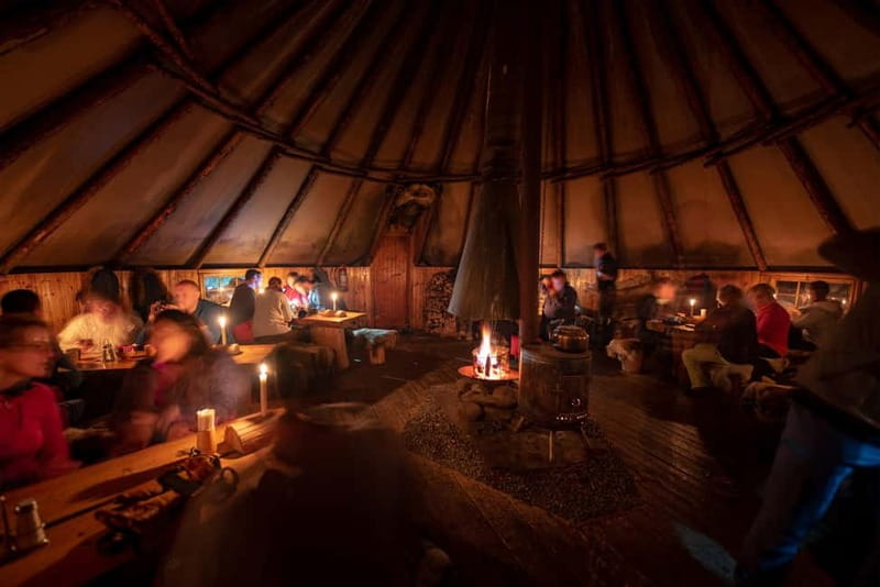 From Tromsø: Snowmobiling at Camp Tamok & Snow Park Visit - Camp Tamok lavvu lunch: hot stew by the fire and meeting huskies and reindeer