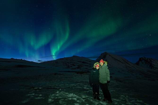 Tromsø Northern Lights with Campfire and Professional Photos - Cold-weather comfort: thermo suit, warmers, chai, and safety tools